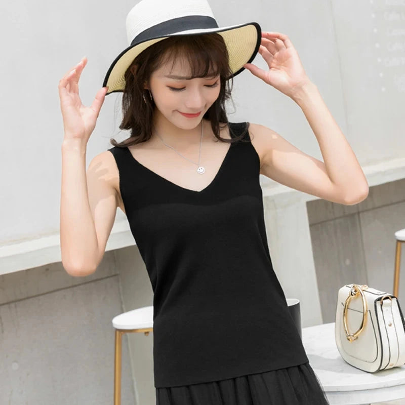 Refined backless padded V-neck tank top in a nylon and viscose blend, designed for casual wear and layering.