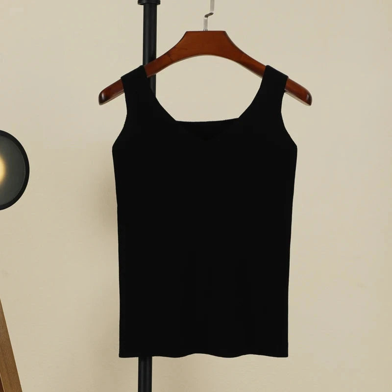 Refined backless padded V-neck tank top in midnight black, made from a nylon and viscose blend. Regular length and medium str