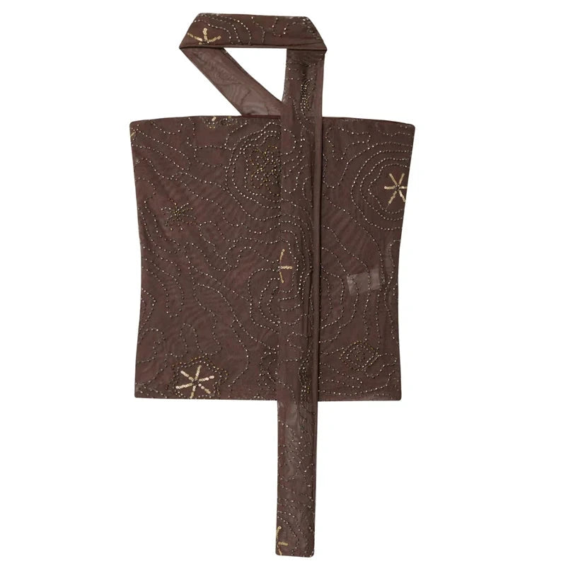 Strapless tulle beaded corset crop top with a backless design and semi-sheer fabric, perfect for evening wear.