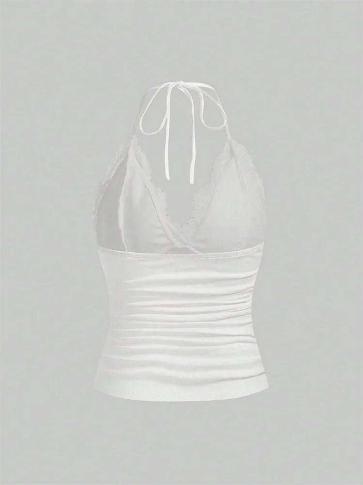 Black lace patchwork halter top with ruched back and backless design. Made from polyester and spandex.